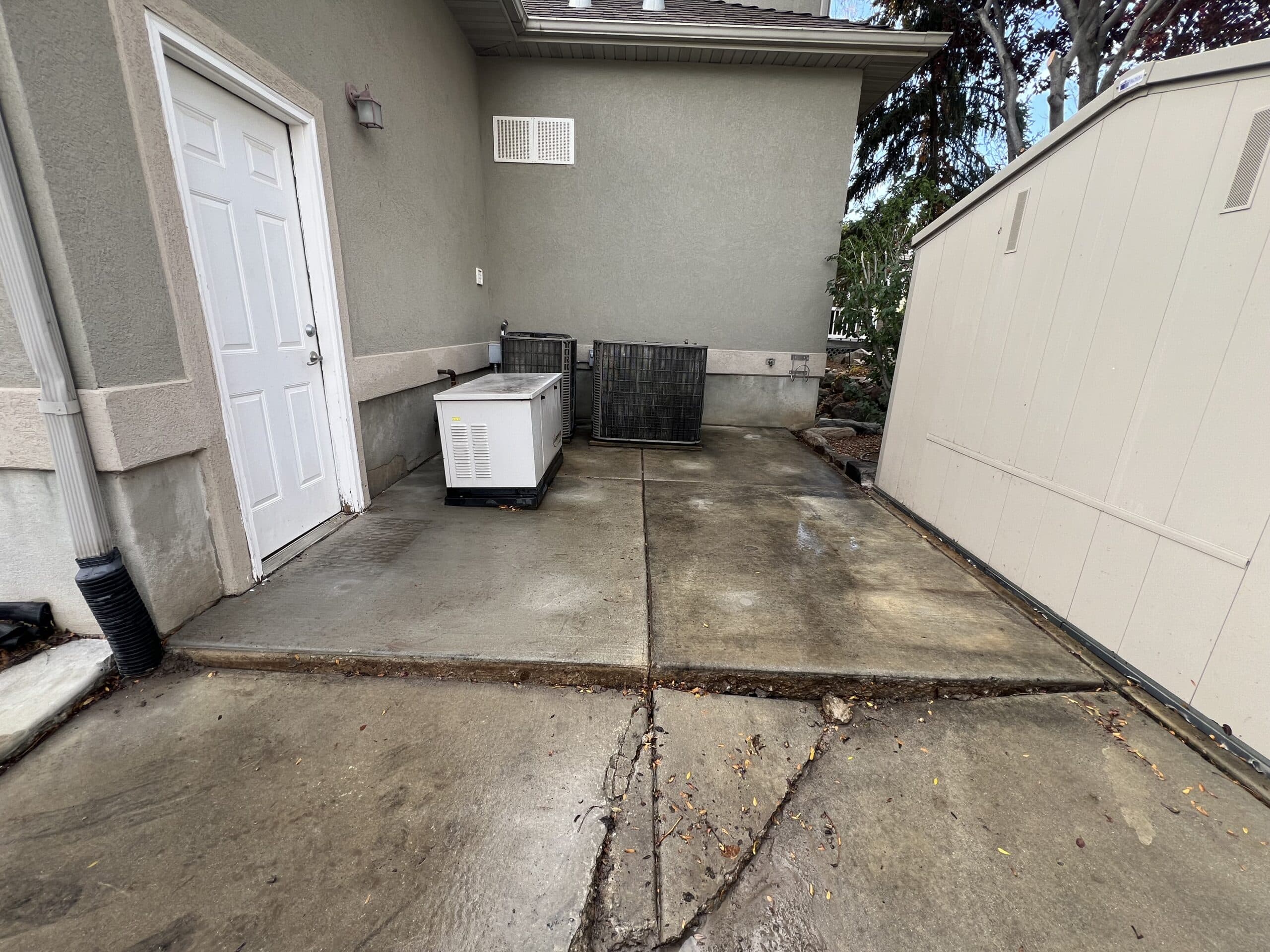 Same utility pads behind the South Jordan garage after Lift Right Concrete lifted them back to grade